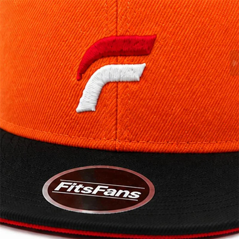 Orange and black snapback cap with embroidered red and white logo and FitsFans sticker