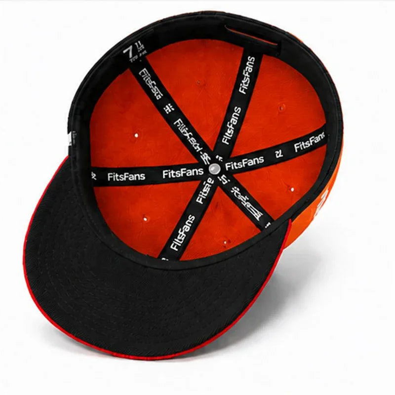 Underside of an orange and black fitted cap with branded interior lining, close-up view