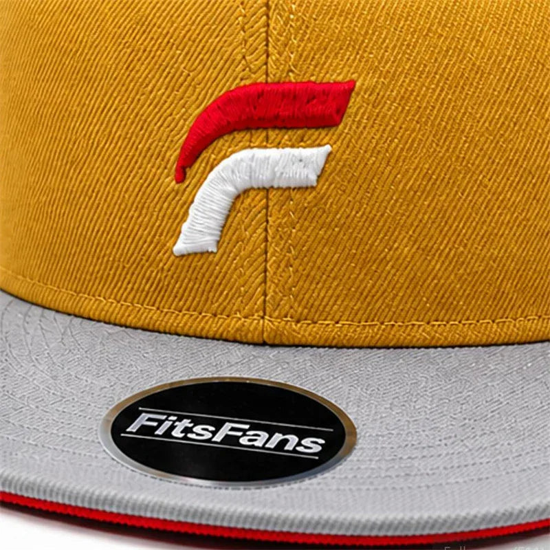 Yellow fitted hat with red and white embroidered logo, gray flat brim, FitsFans sticker