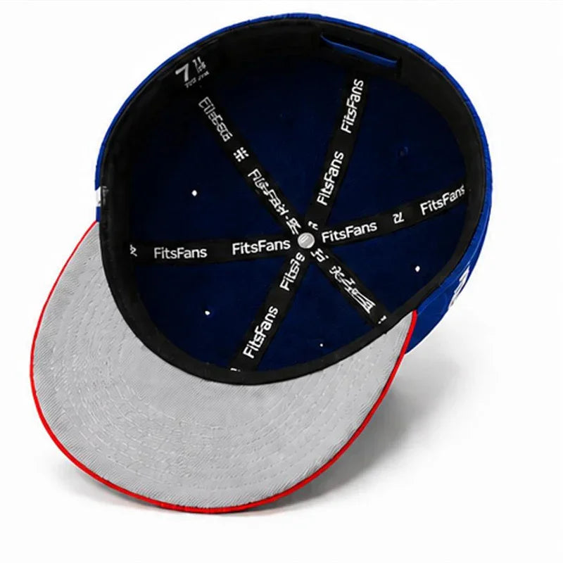 Inside view of blue fitted cap with grey brim, red edge, and logo lining details