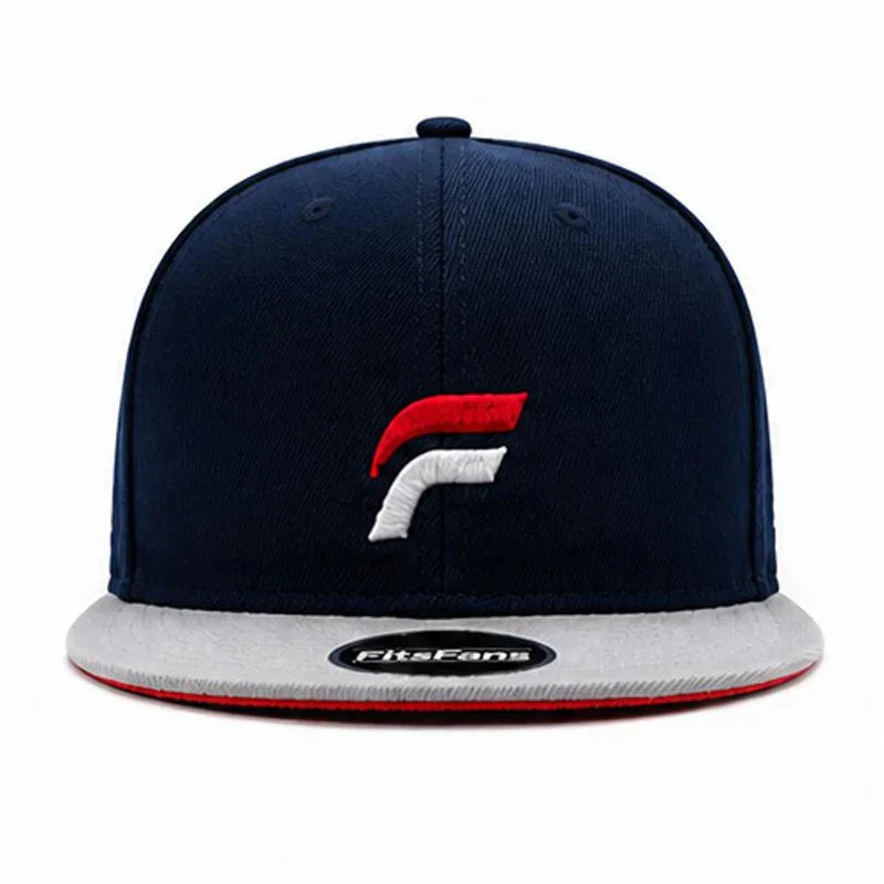 Navy blue snapback hat with red and white embroidered logo, gray brim, and sticker on visor